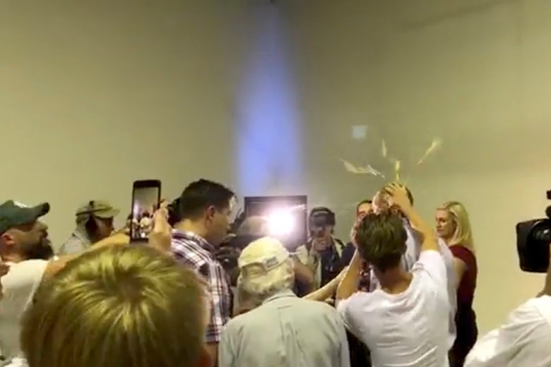 Australian Senator Fraser Anning has an egg smashed on his head while talking to the media in Victoria, Australia on March 16, 2019 in this still image taken from a video obtained from social media.